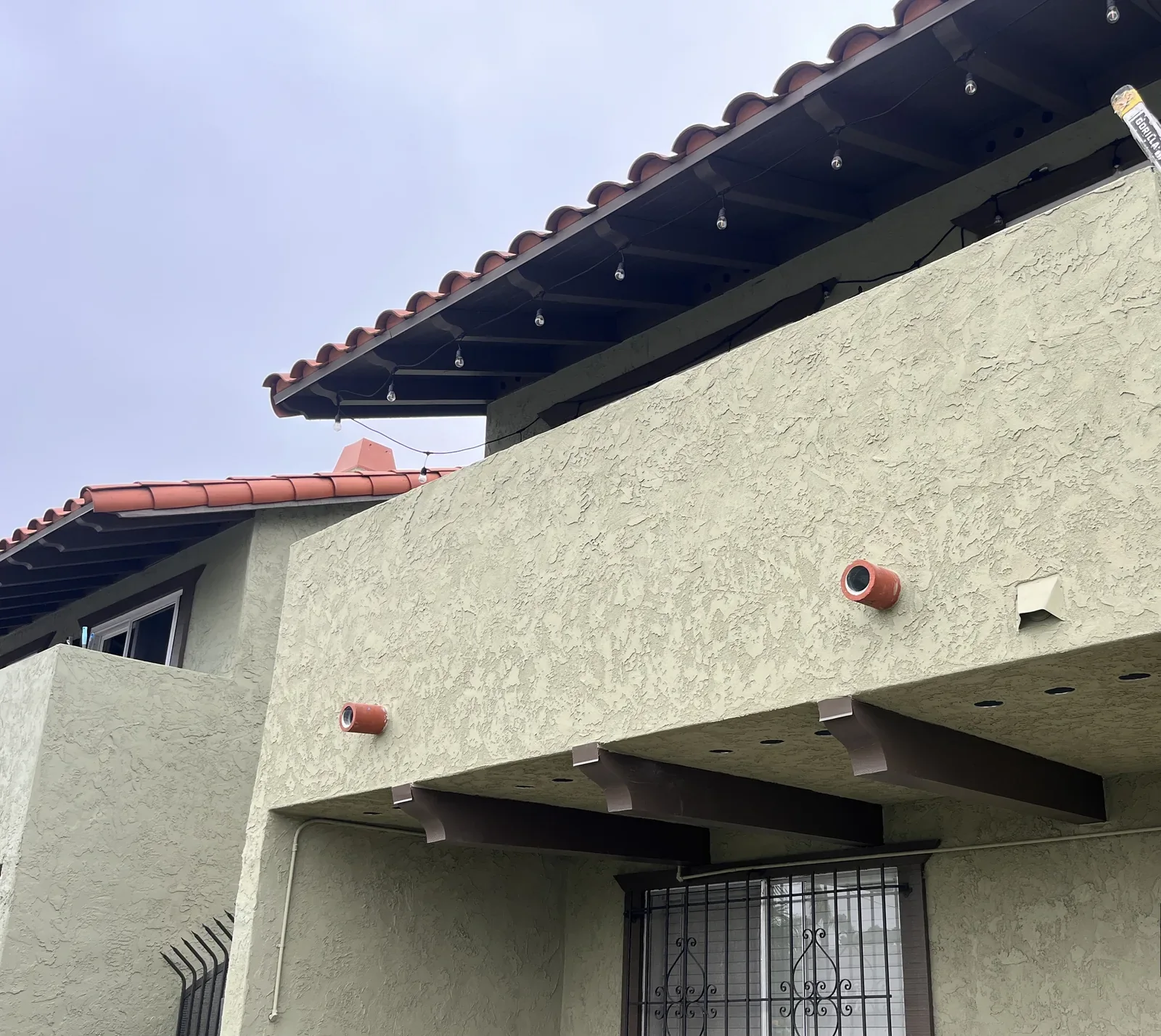 Textured balcony exterior wall and underside photographed from below